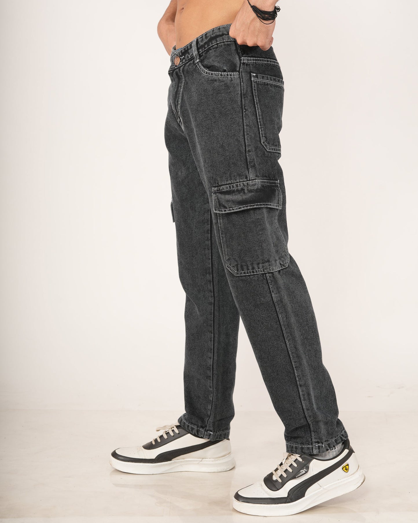 A man wearing black 6-pocket cargo jeans.
