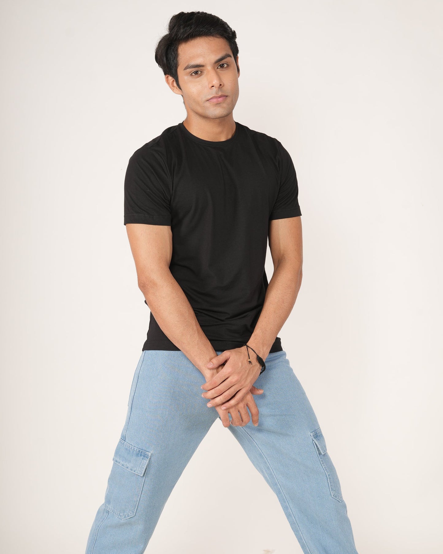 Man wearing a black t-shirt, light blue jeans.