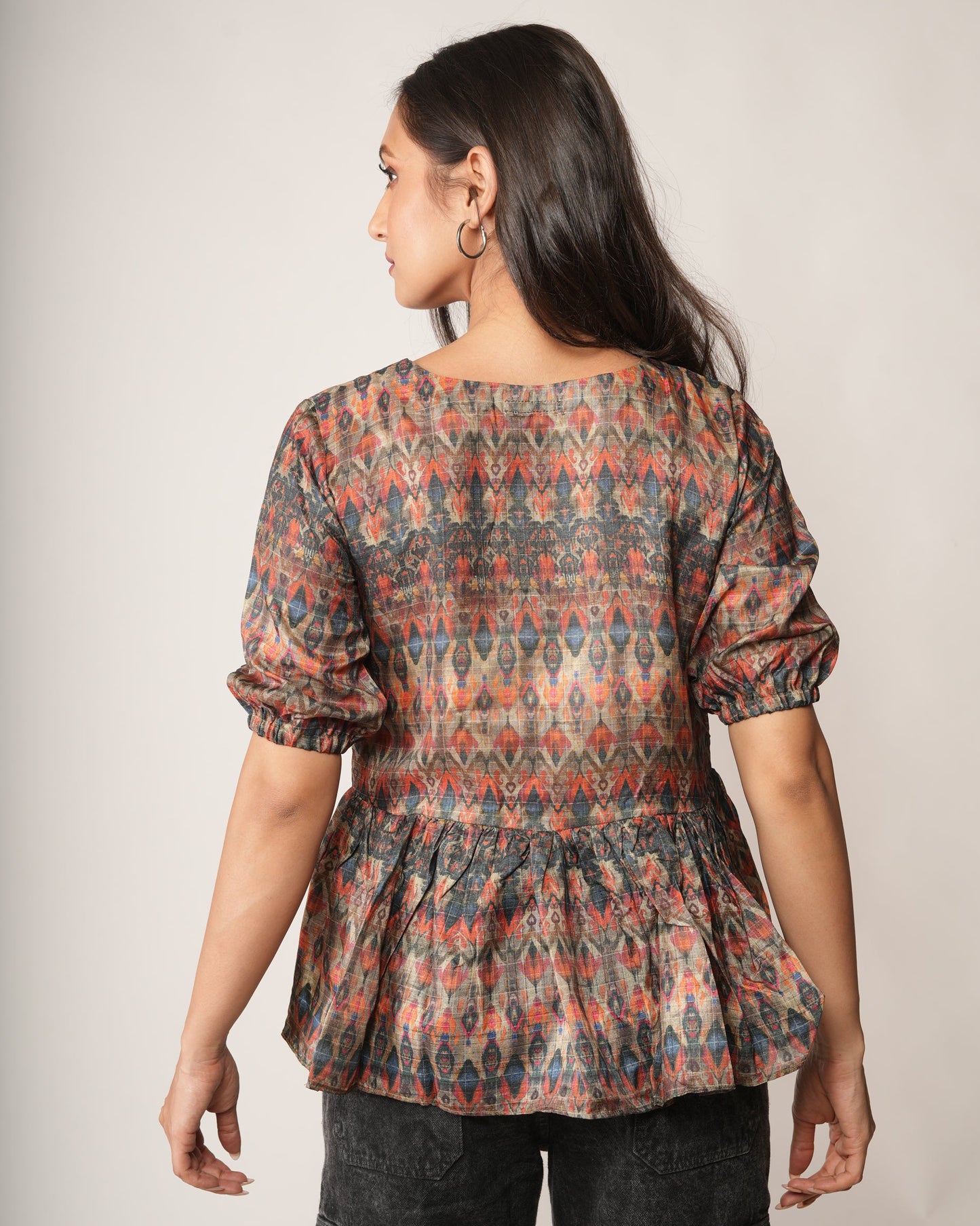 Woman wearing a patterned top.