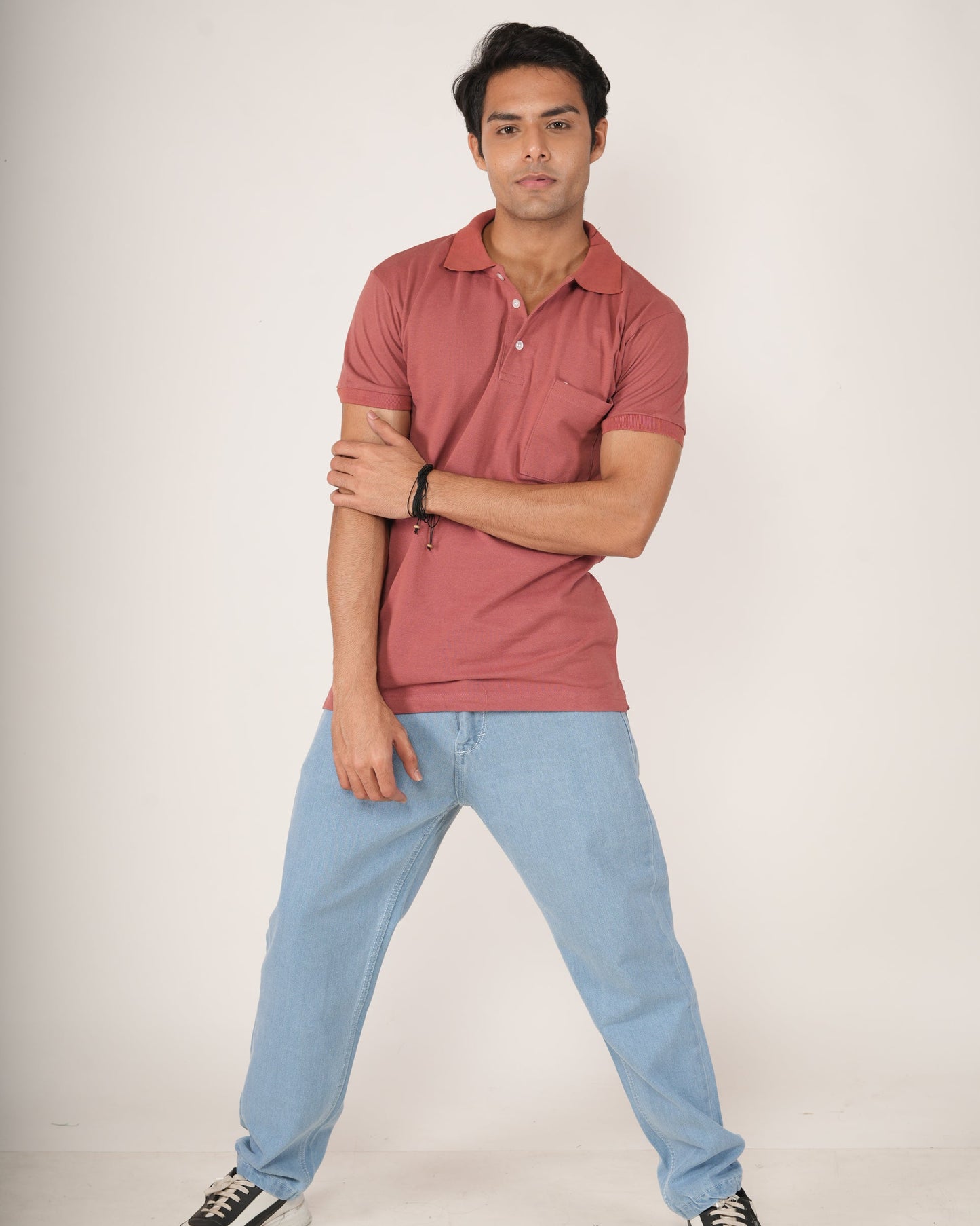 Men wearing a Rust-Red Polo T-shirt and light blue Jeans.