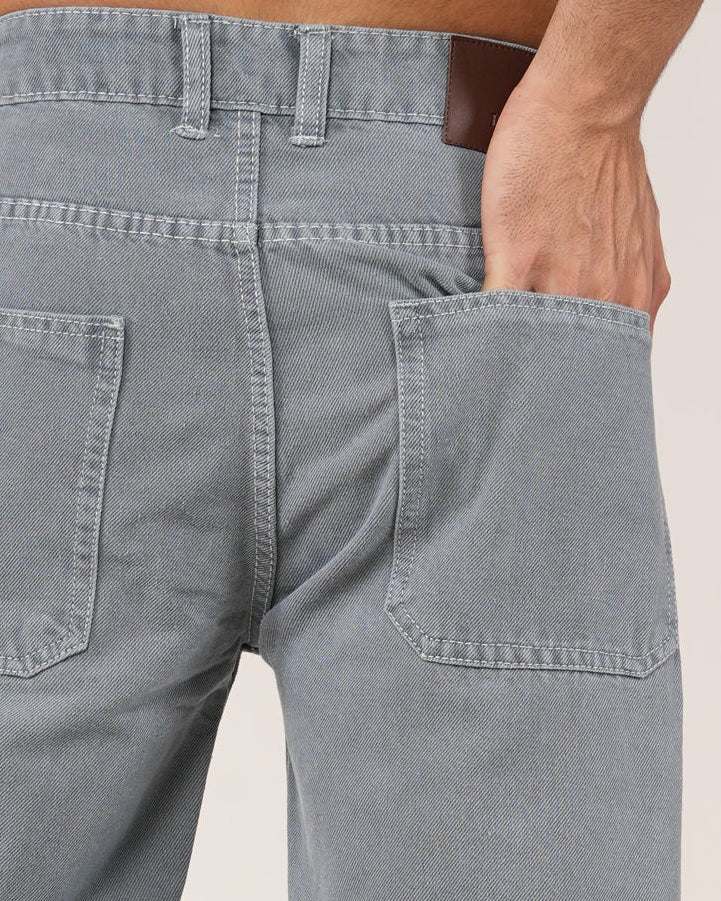 A man wearing Slate Grey Relaxed Straight Jeans, shown from the chest down against a plain light studio background.