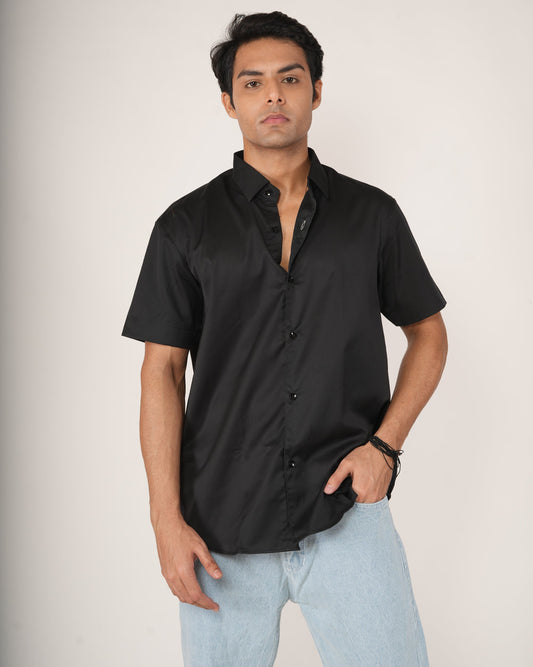 Man wearing a black half-sleeve shirt and light blue jeans.
