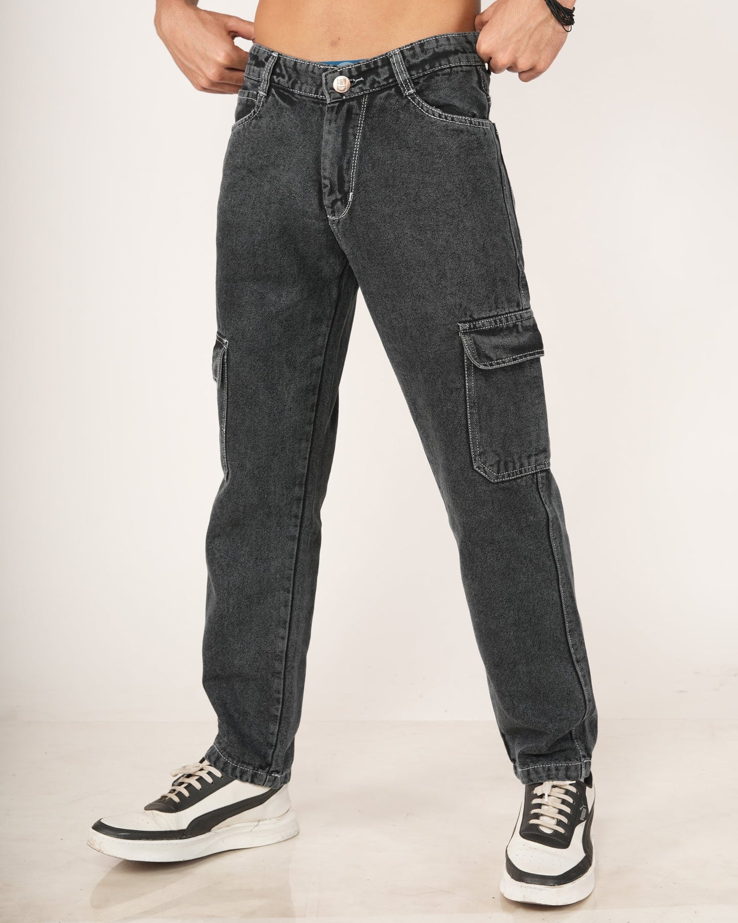 A man wearing black 6-pocket cargo jeans.