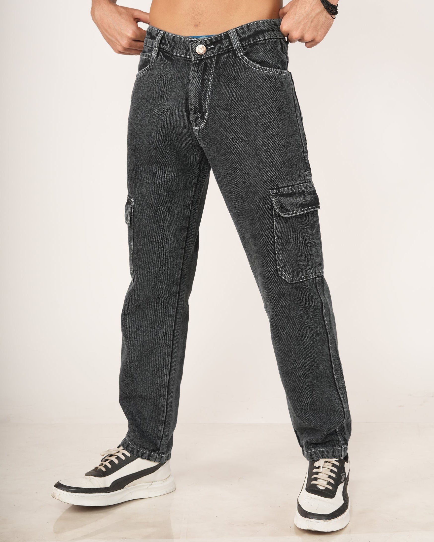 A man wearing black 6-pocket cargo jeans.