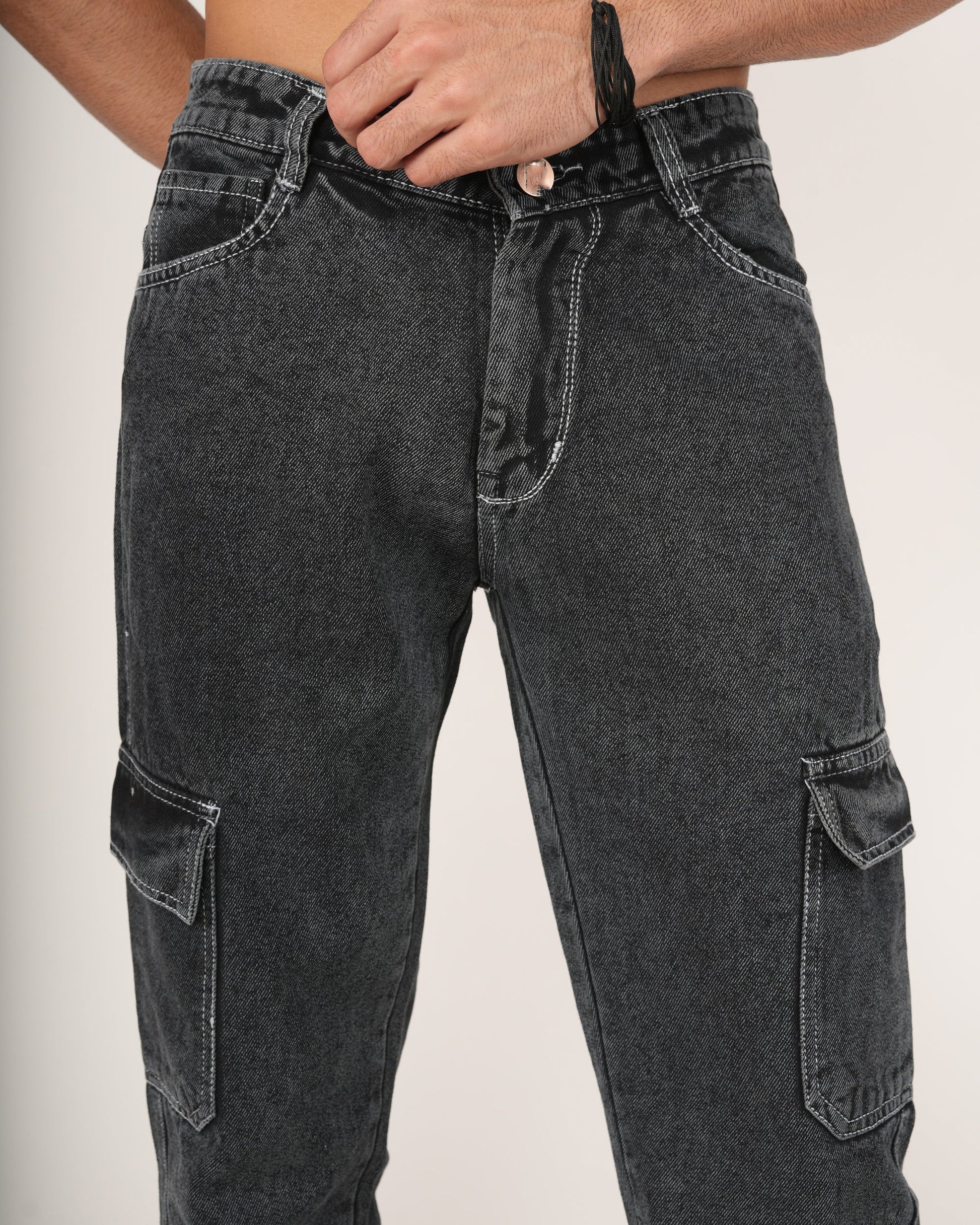 A man wearing black 6-pocket cargo jeans.