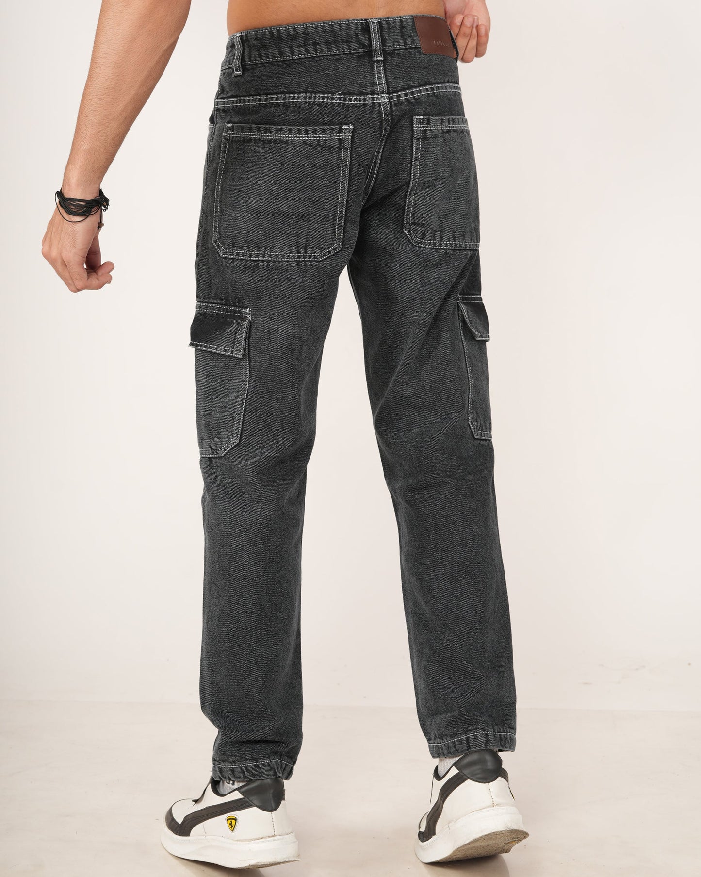 A man wearing black 6-pocket cargo jeans.
