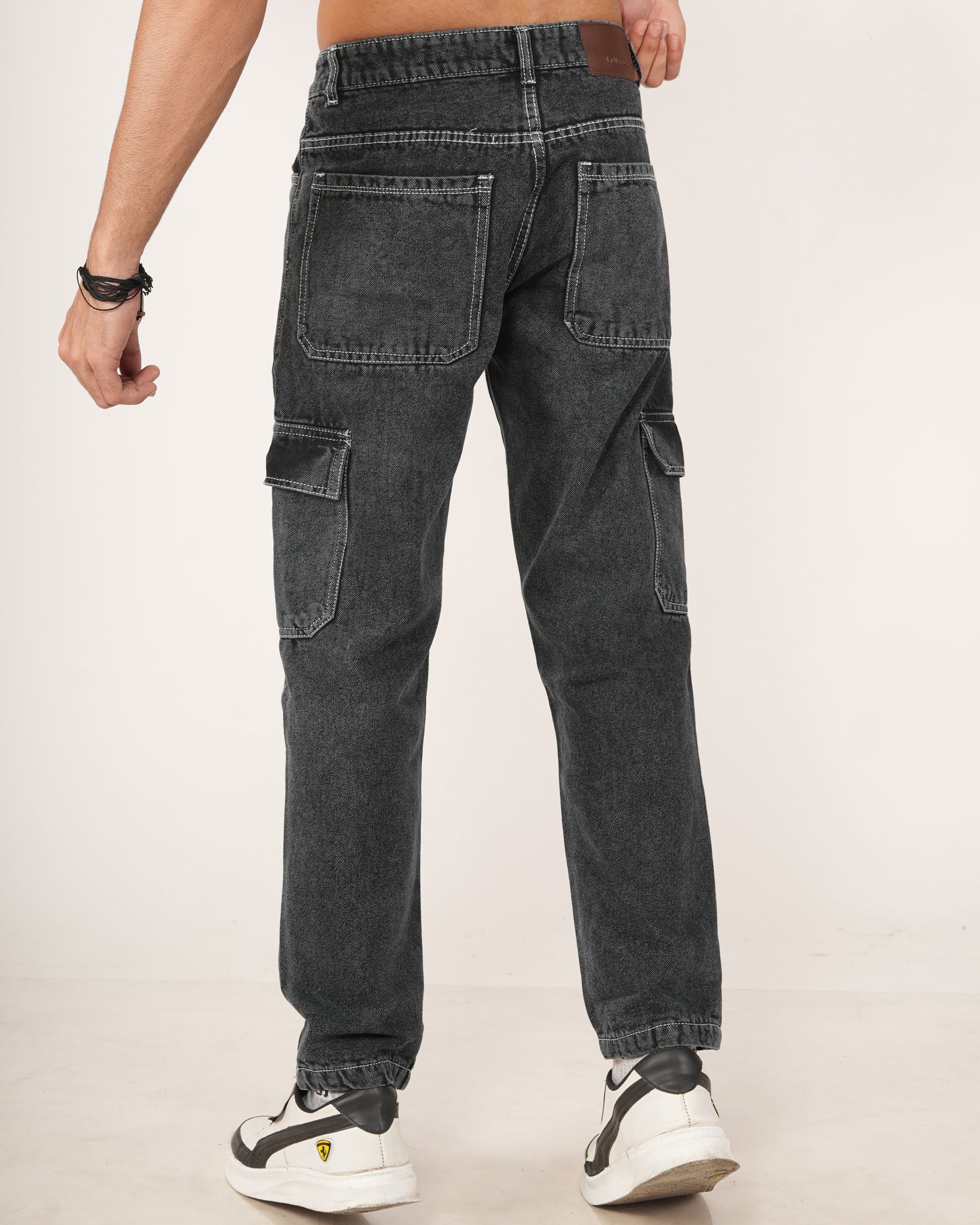 A man wearing black 6-pocket cargo jeans.