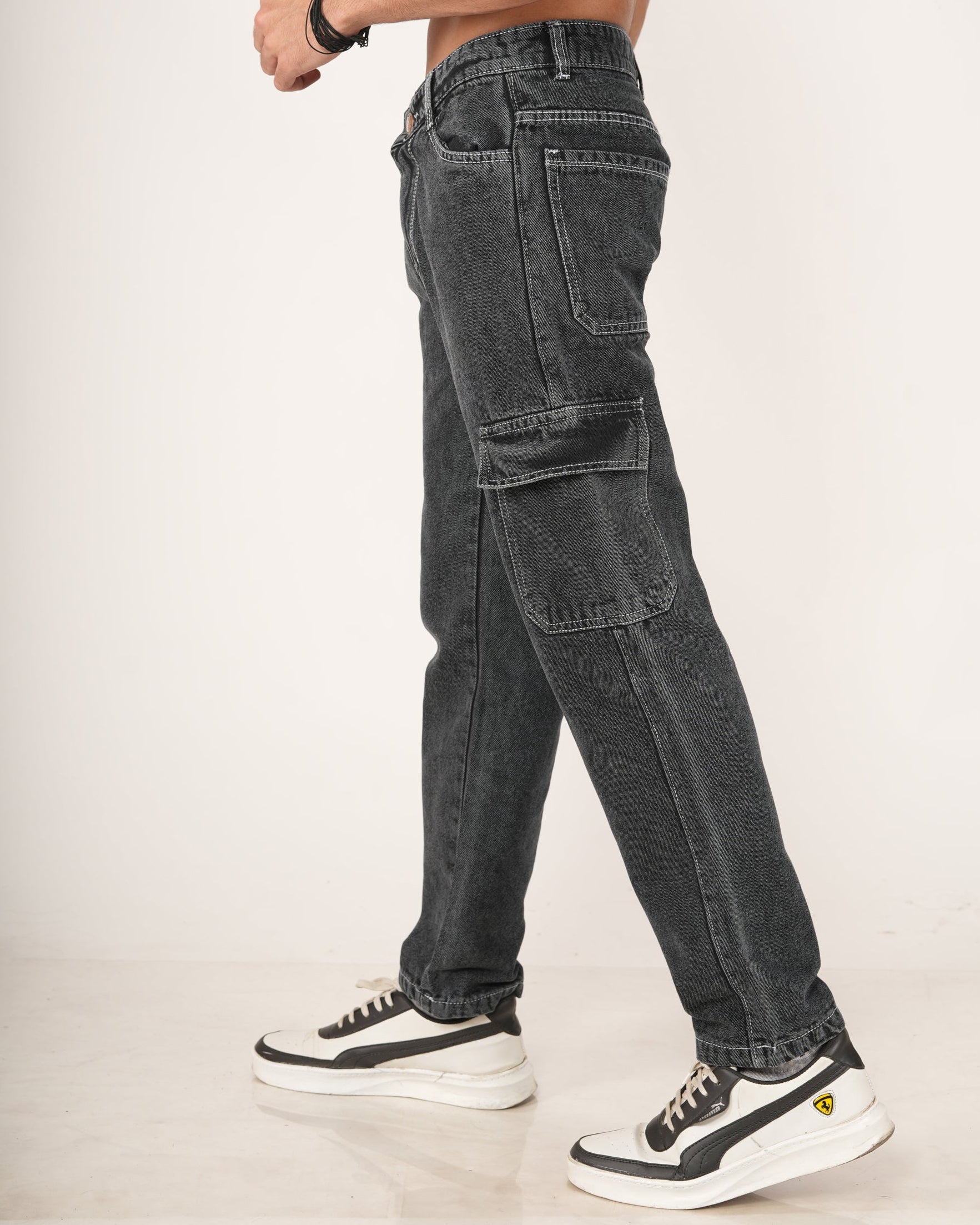 A man wearing black 6-pocket cargo jeans.