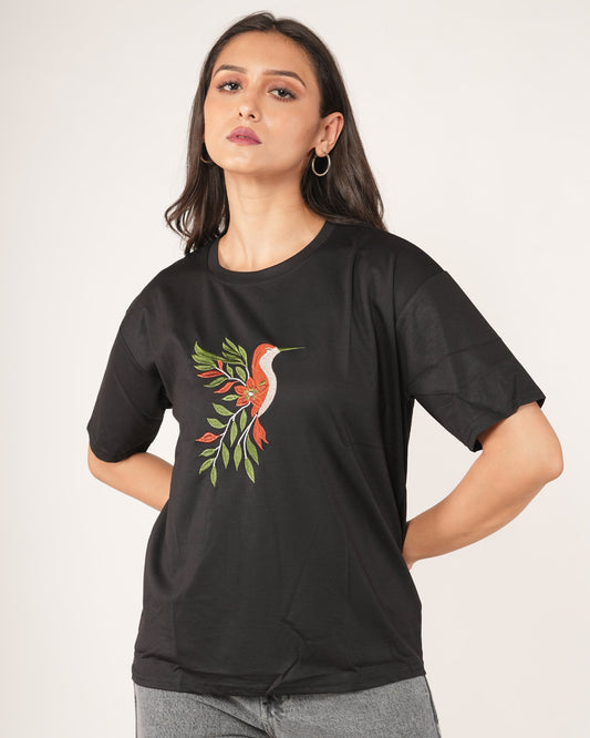 Woman wearing a Black Hummingbird Embroidered Oversized T-Shirt.