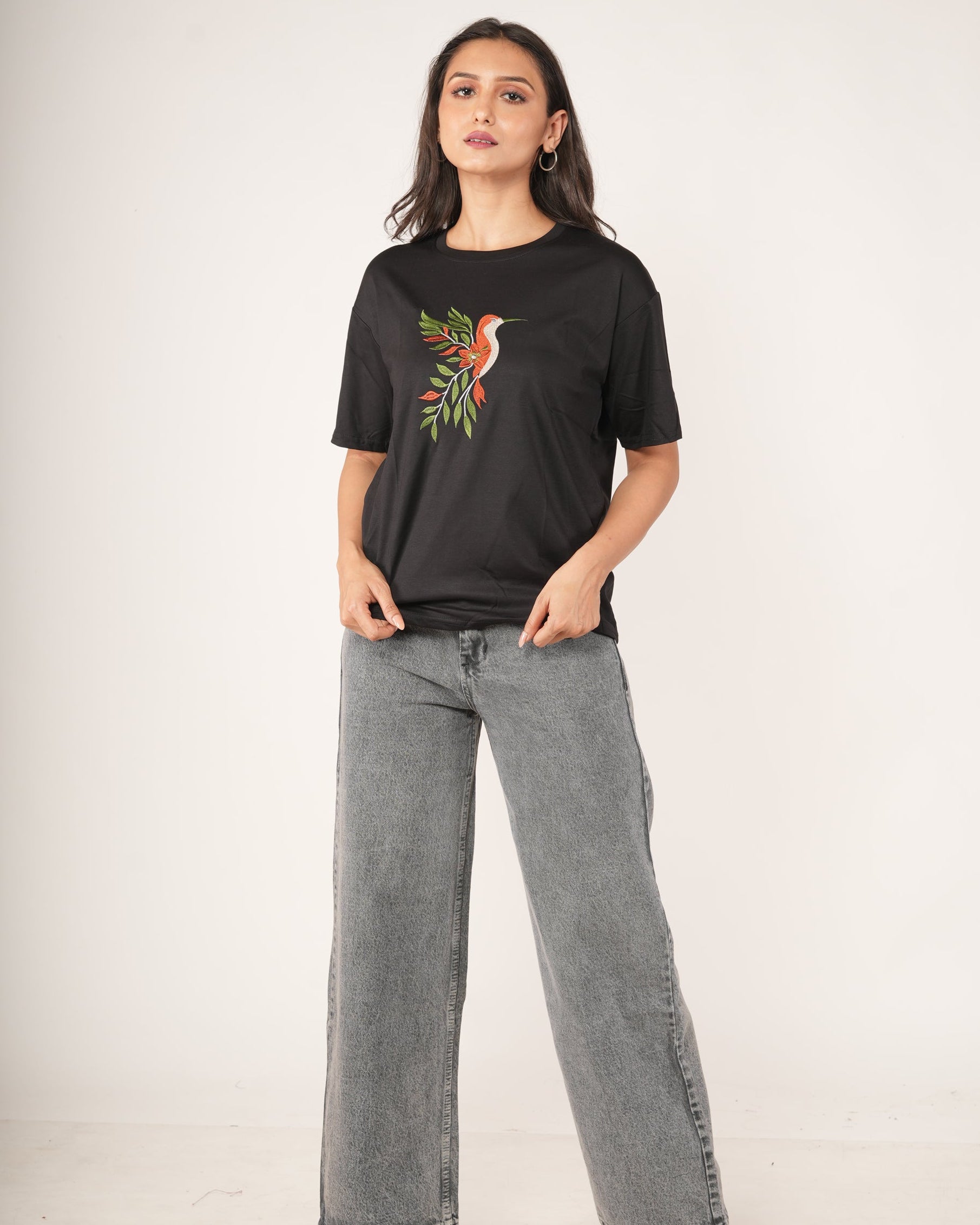 Woman wearing a Black Hummingbird Embroidered Oversized T-Shirt.