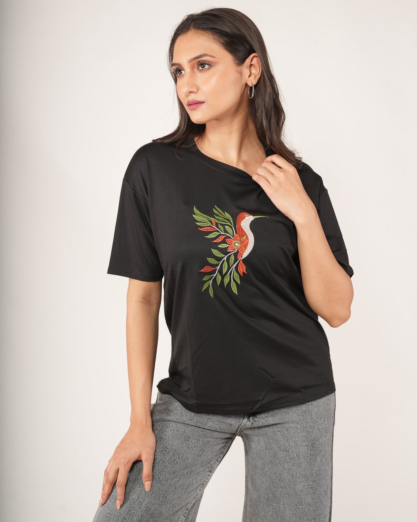 Woman wearing a Black Hummingbird Embroidered Oversized T-Shirt.