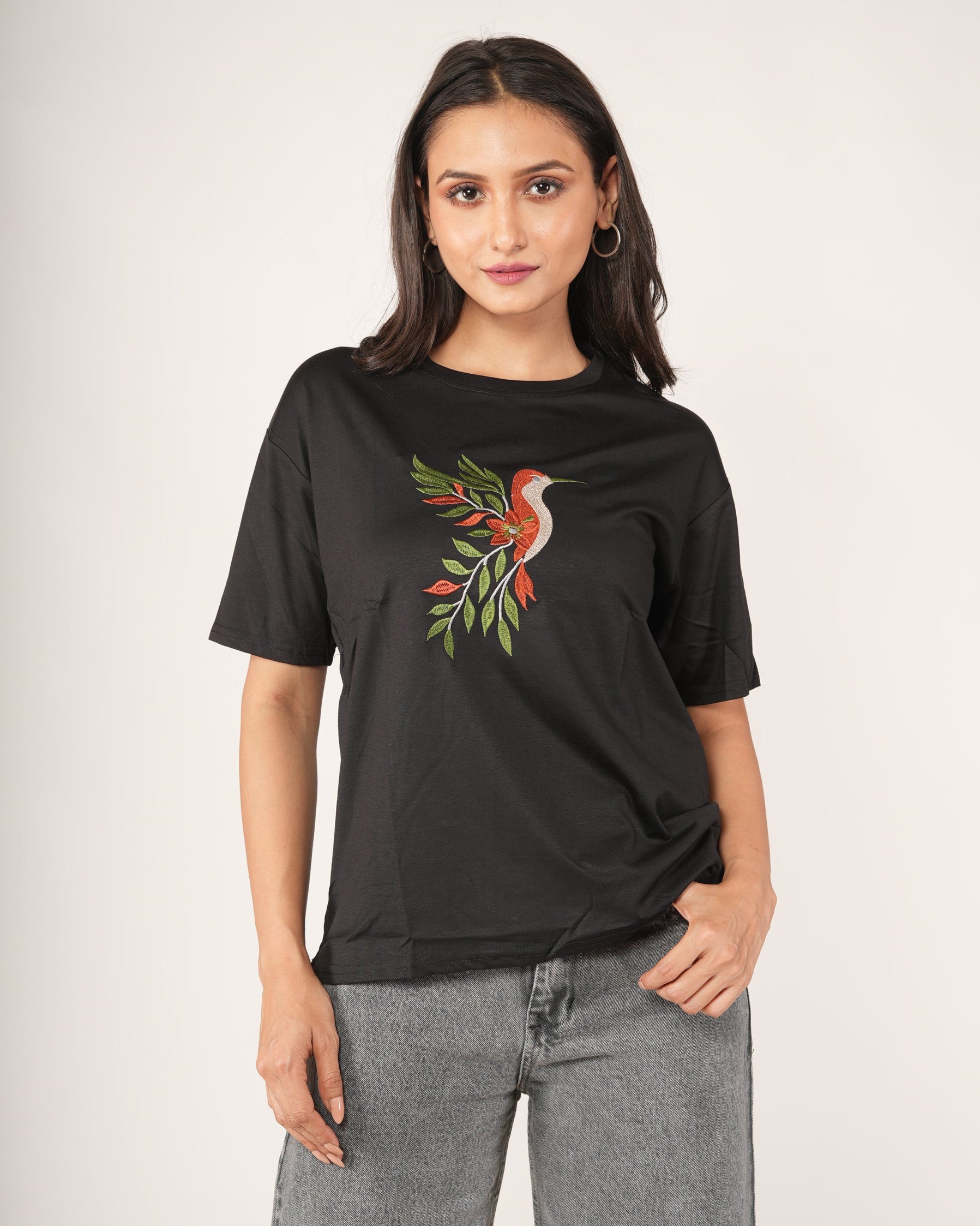 Woman wearing a Black Hummingbird Embroidered Oversized T-Shirt.