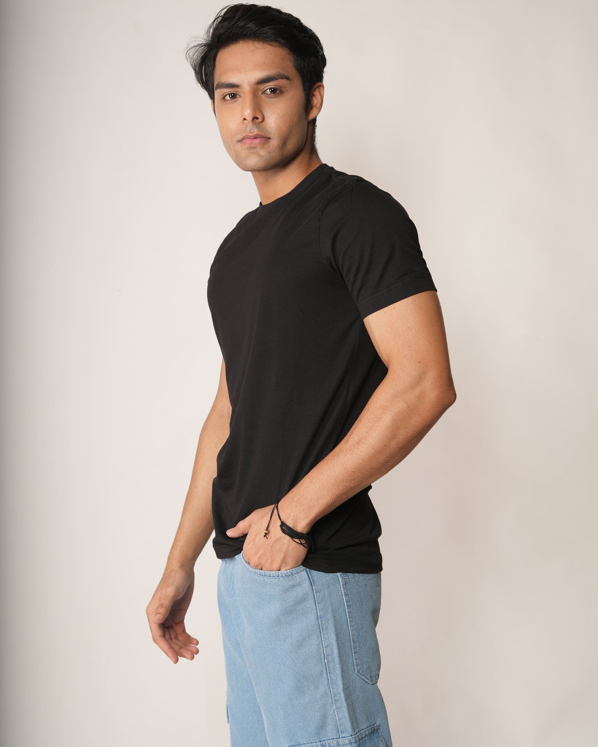 Men wearing a Black slim fit crew neck t-shirt and icy-blue 6 pocket jeans.