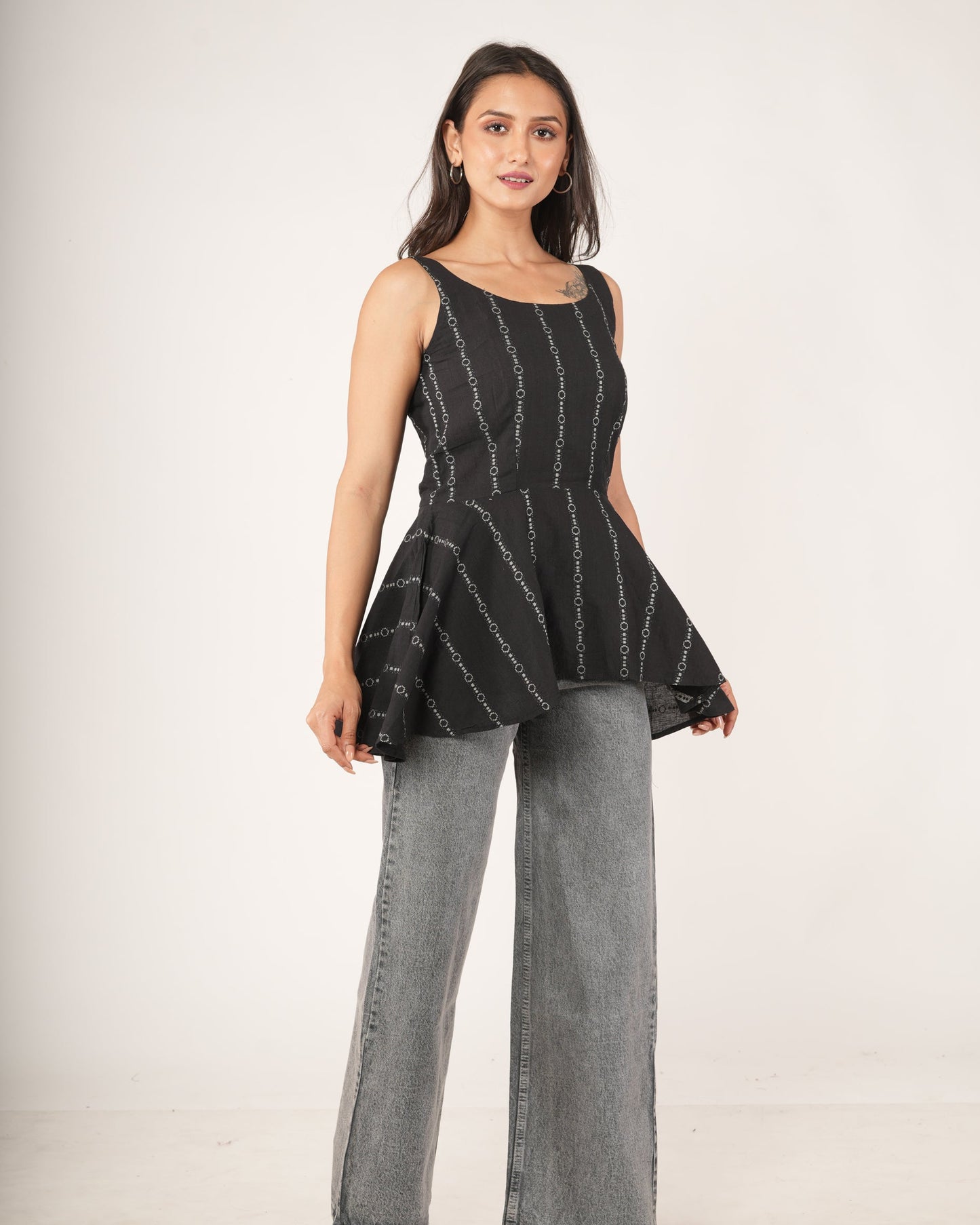 Women wearing Black striped flared top.
