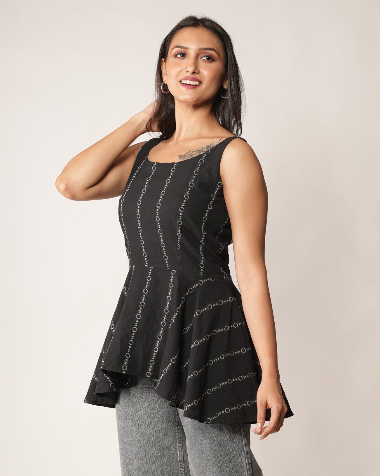 Women wearing a Black striped flared top.