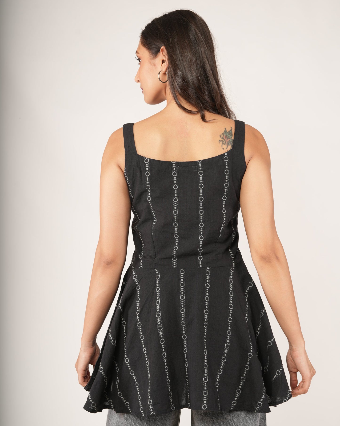 Women wearing a black striped flared top