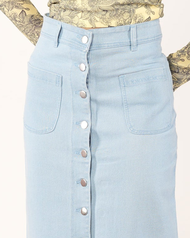 A woman modeling a light blue denim midi skirt with a front button closure.