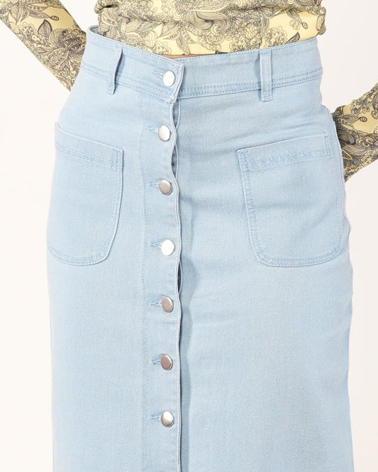 A woman modeling a light blue denim midi skirt with a front button closure.