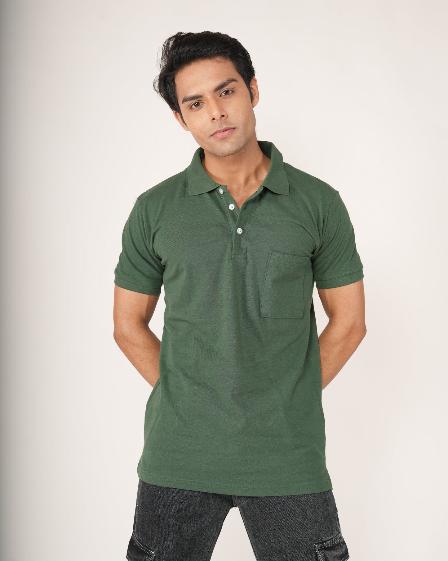 Man wearing a green polo shirt against a white background
