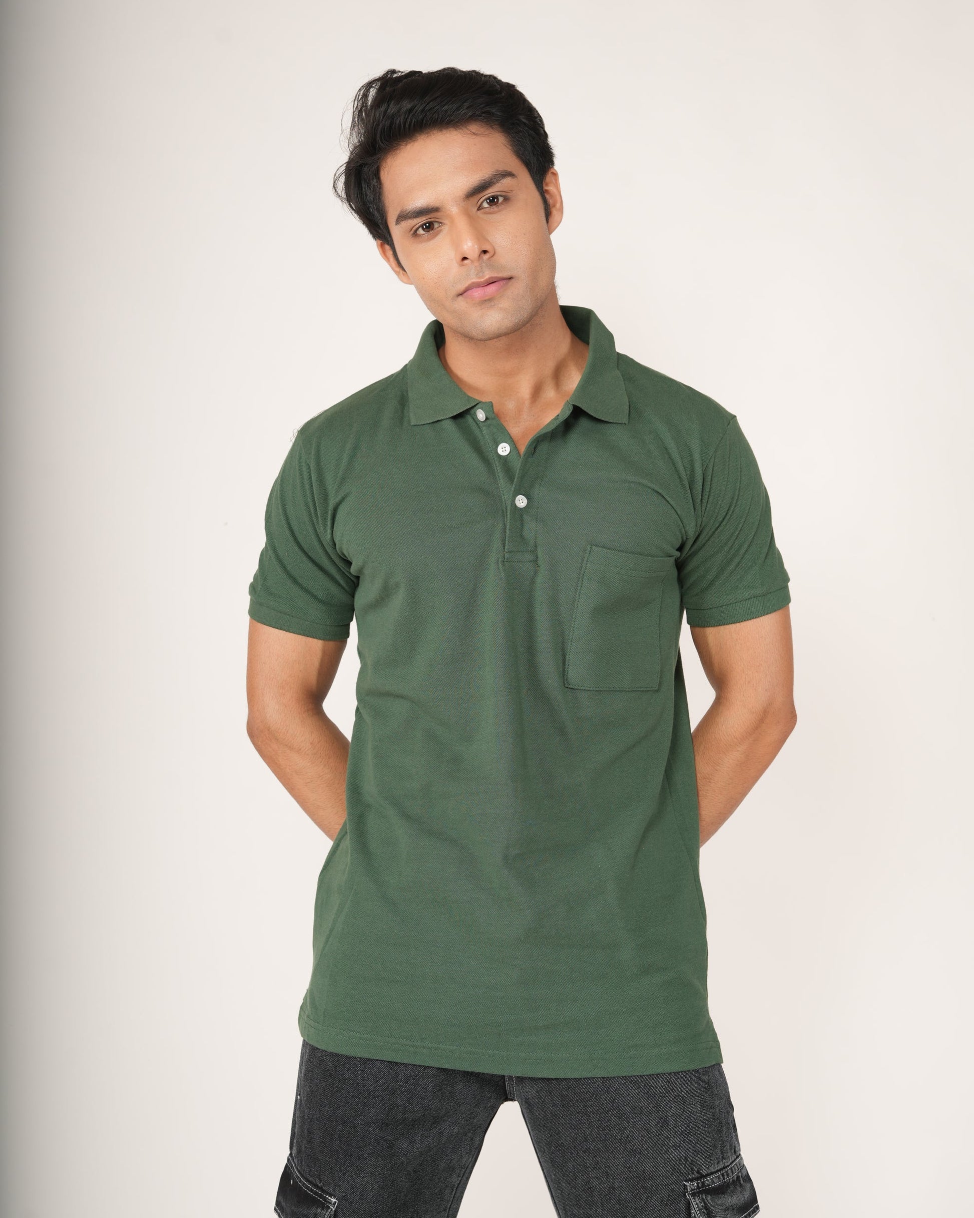 Man wearing a green polo shirt against a white background