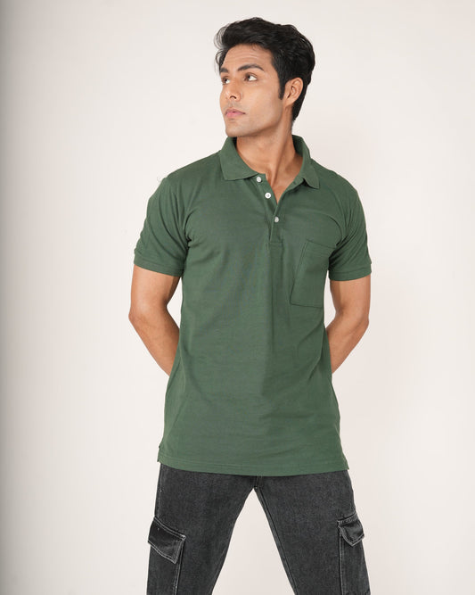 Man wearing a green polo shirt and dark pants on a white background