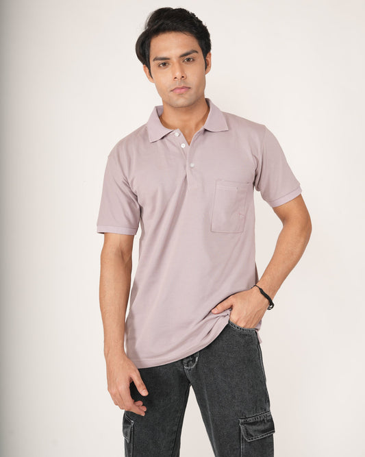 Man wearing a light purple polo shirt and dark jeans.