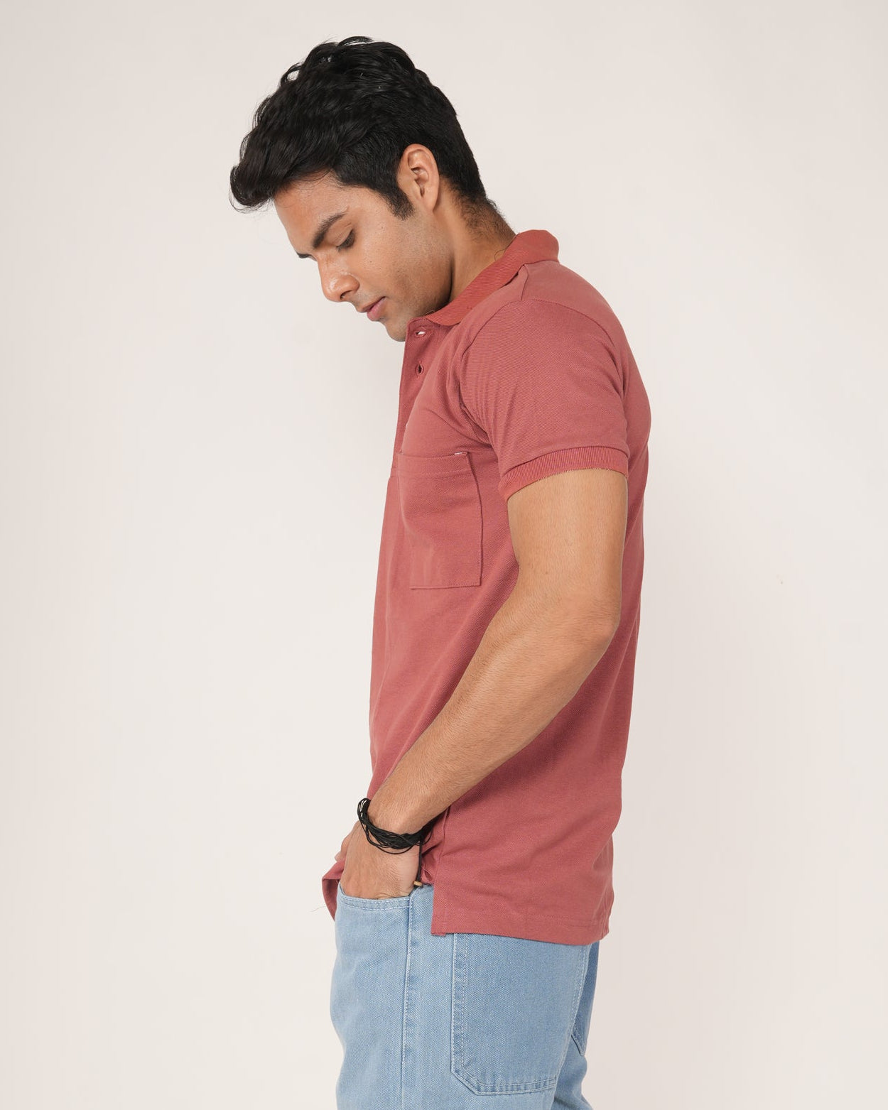 Men wearing a Rust-Red Polo T-shirt and light blue Jeans.