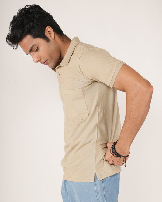Man wearing a Sand/beige polo shirt and light blue jeans.