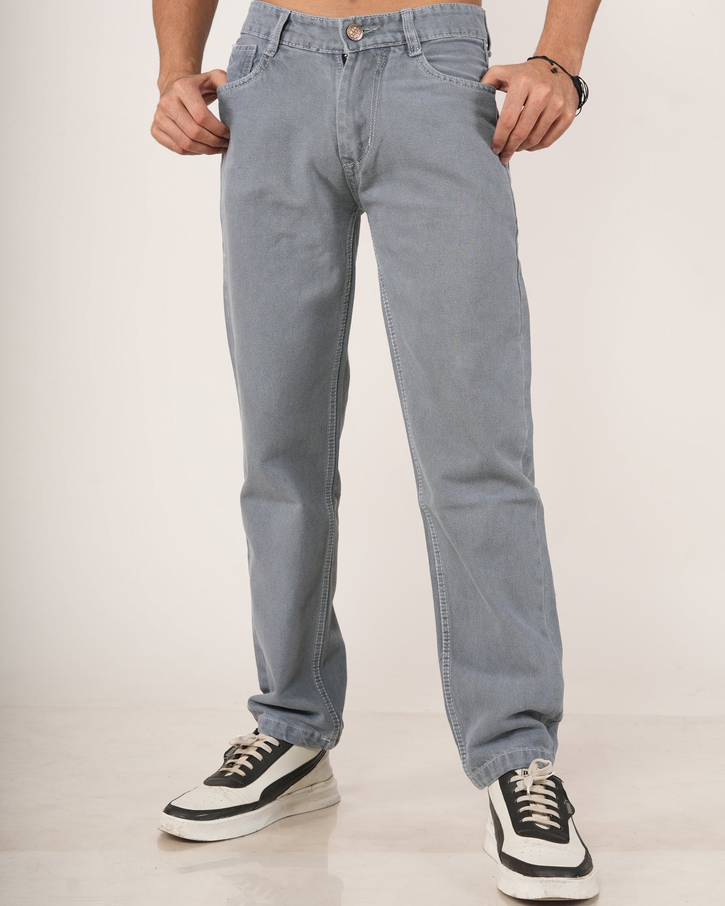 A man wearing Slate Grey Relaxed Straight Jeans, shown from the chest down against a plain light studio background.