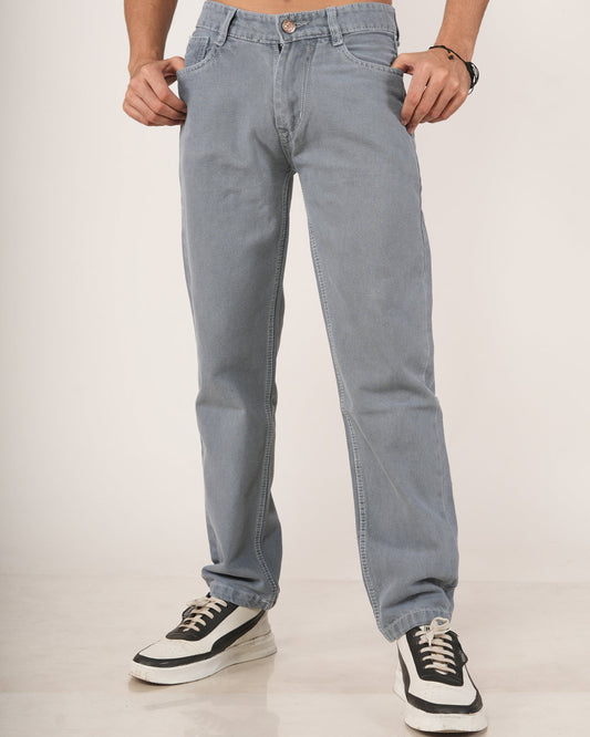 A man wearing Slate Grey Relaxed Straight Jeans, shown from the chest down against a plain light studio background.