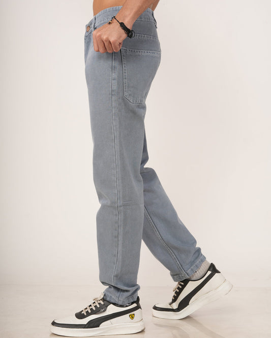 A man wearing Slate Grey Relaxed Straight Jeans, shown from the chest down against a plain light studio background.