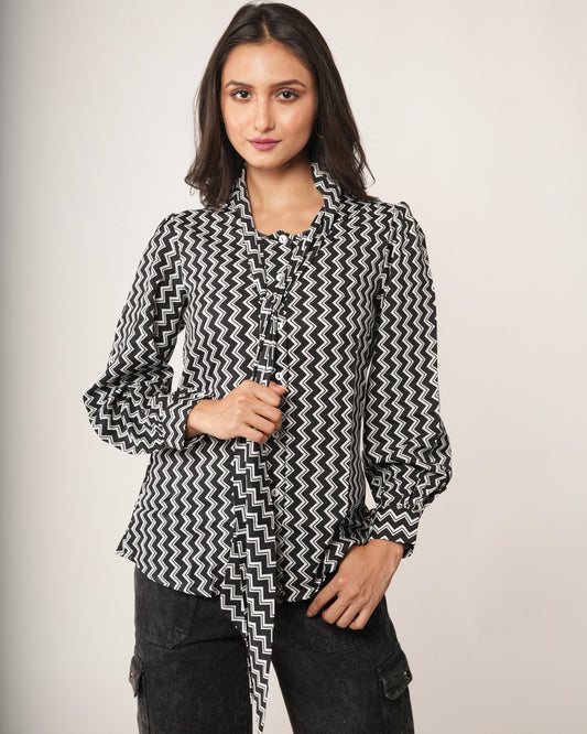 Woman wearing a black and white patterned shirt.
