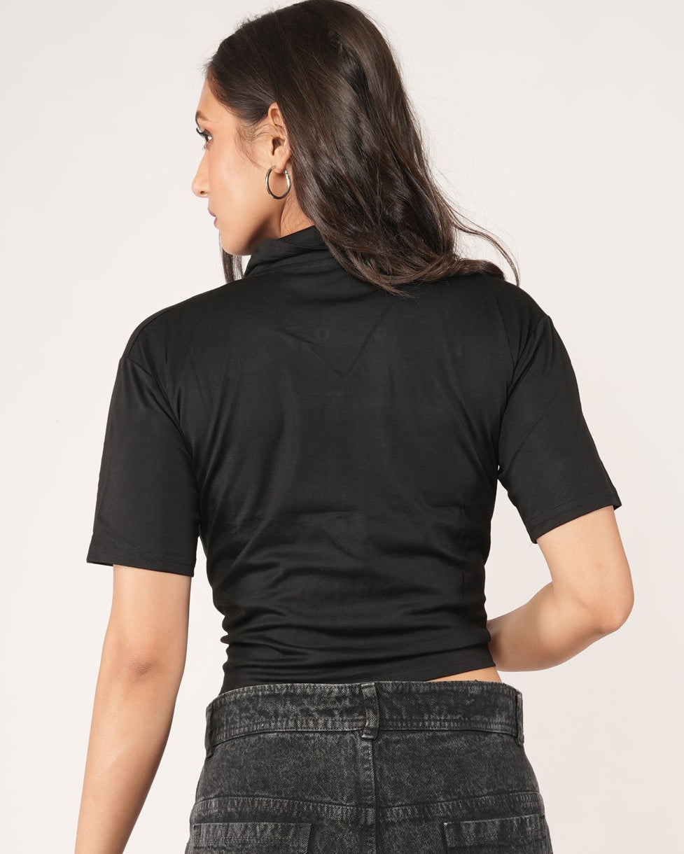 Person wearing a black printed t-shirt and dark gray cargo pants.