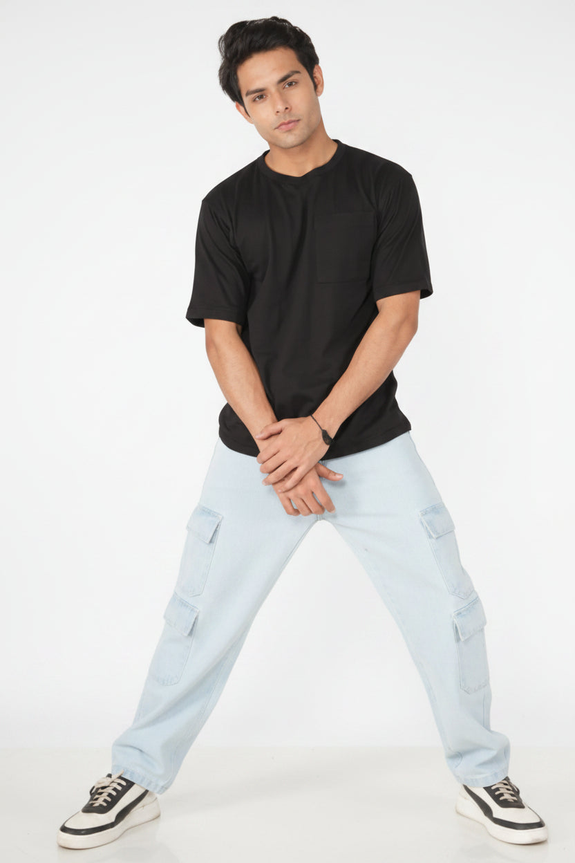 Man wearing a black t-shirt and light blue jeans on a white background