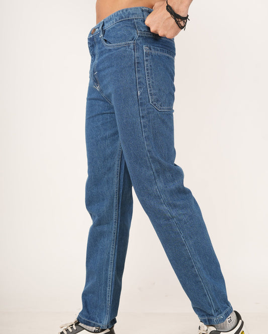 Man wearing blue jeans and black and white sneakers.