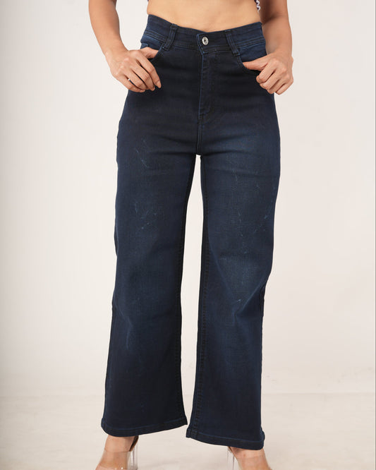 A model wearing dark blue wide-leg jeans, paired with a light purple cropped top.