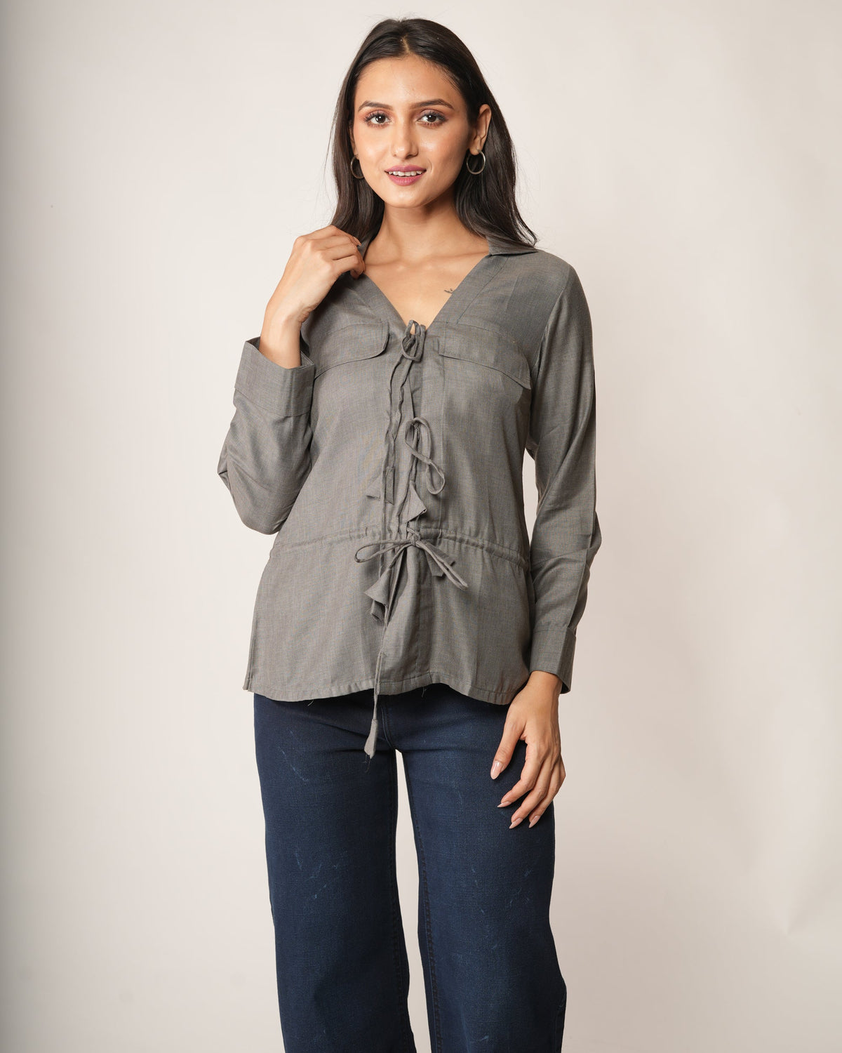 A woman modeling a gray long-sleeve top