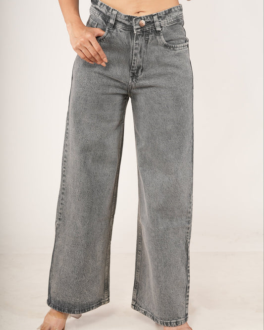 Person wearing gray wide-leg jeans on a plain background