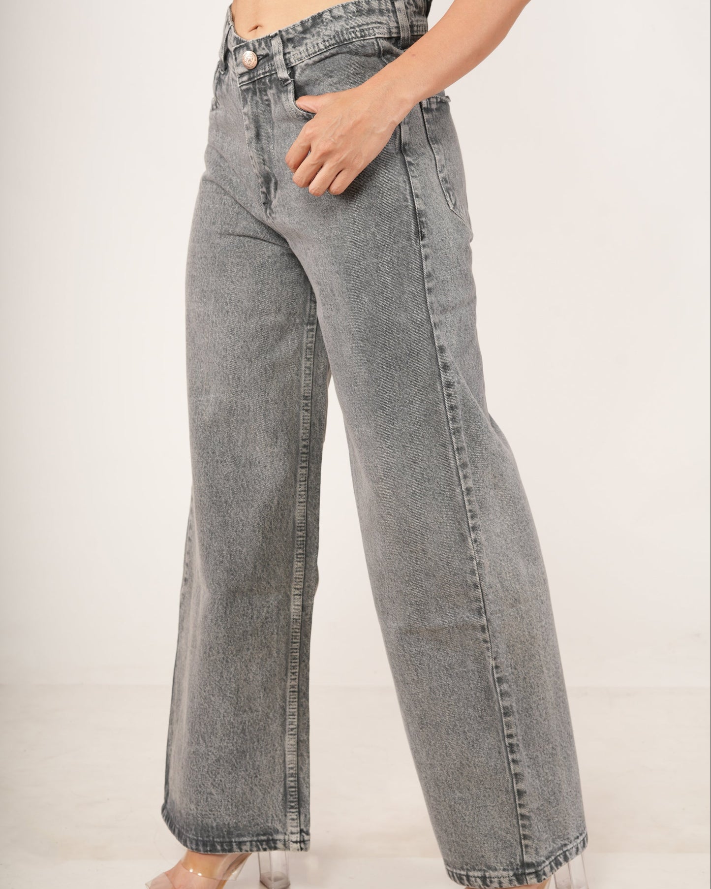 A person wearing high-waisted, wide-leg gray denim jeans with a faded wash.