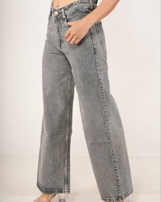 A person wearing high-waisted, wide-leg gray denim jeans with a faded wash.