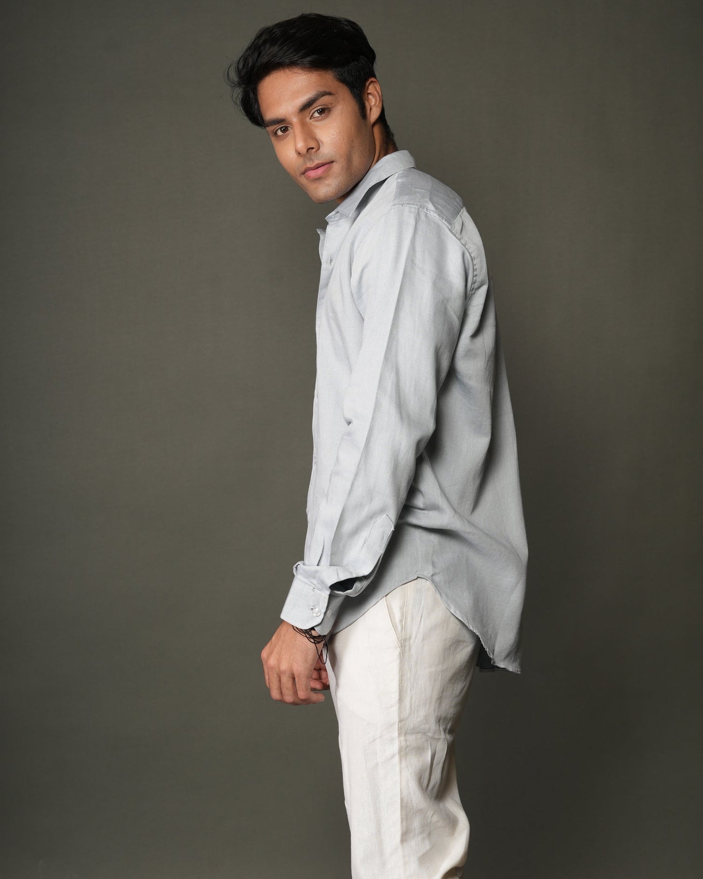 Man wearing a ice blue shirt and white pants.