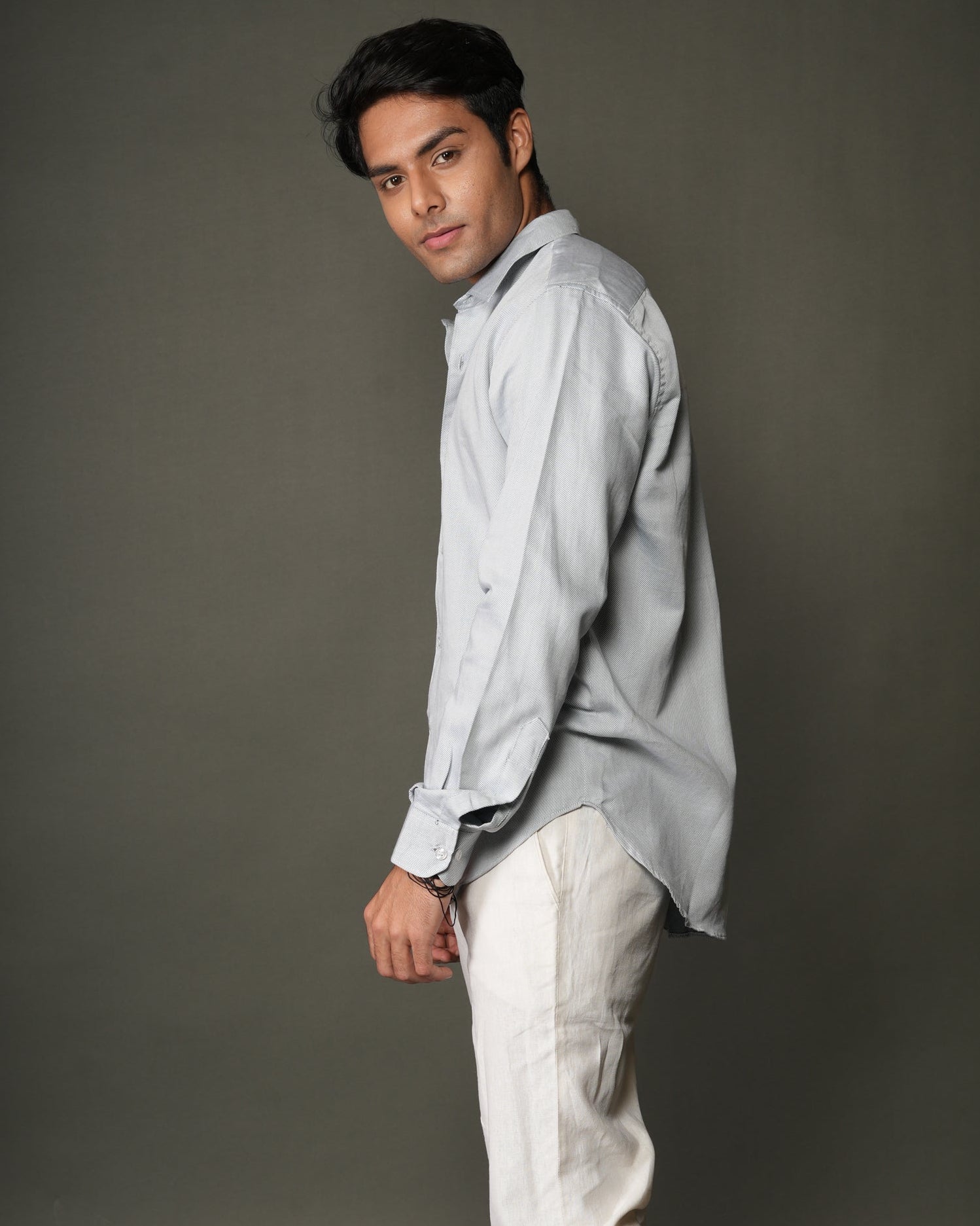 Man wearing a ice blue shirt and white pants.