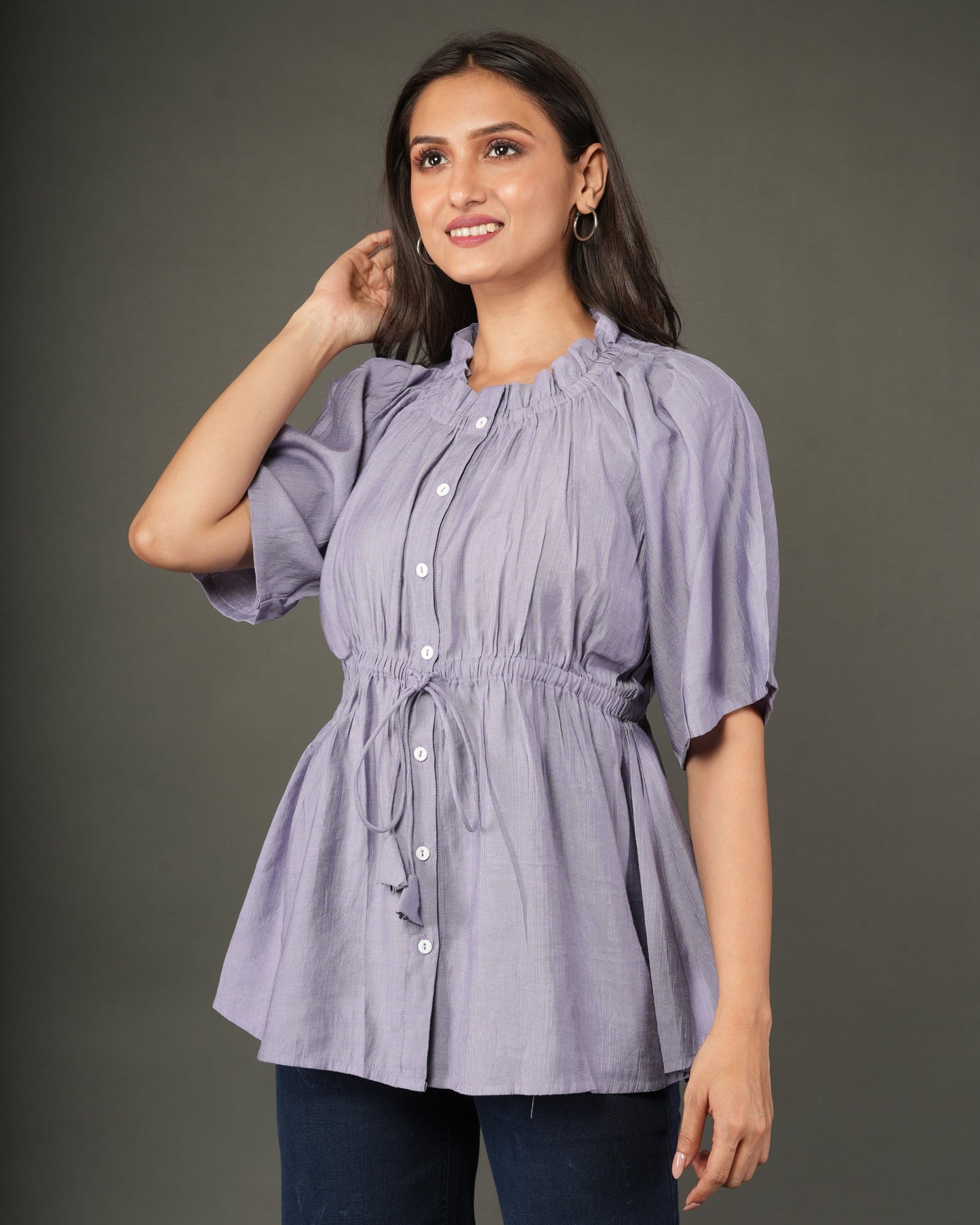 A woman modeling a lavender short-sleeve peplum top