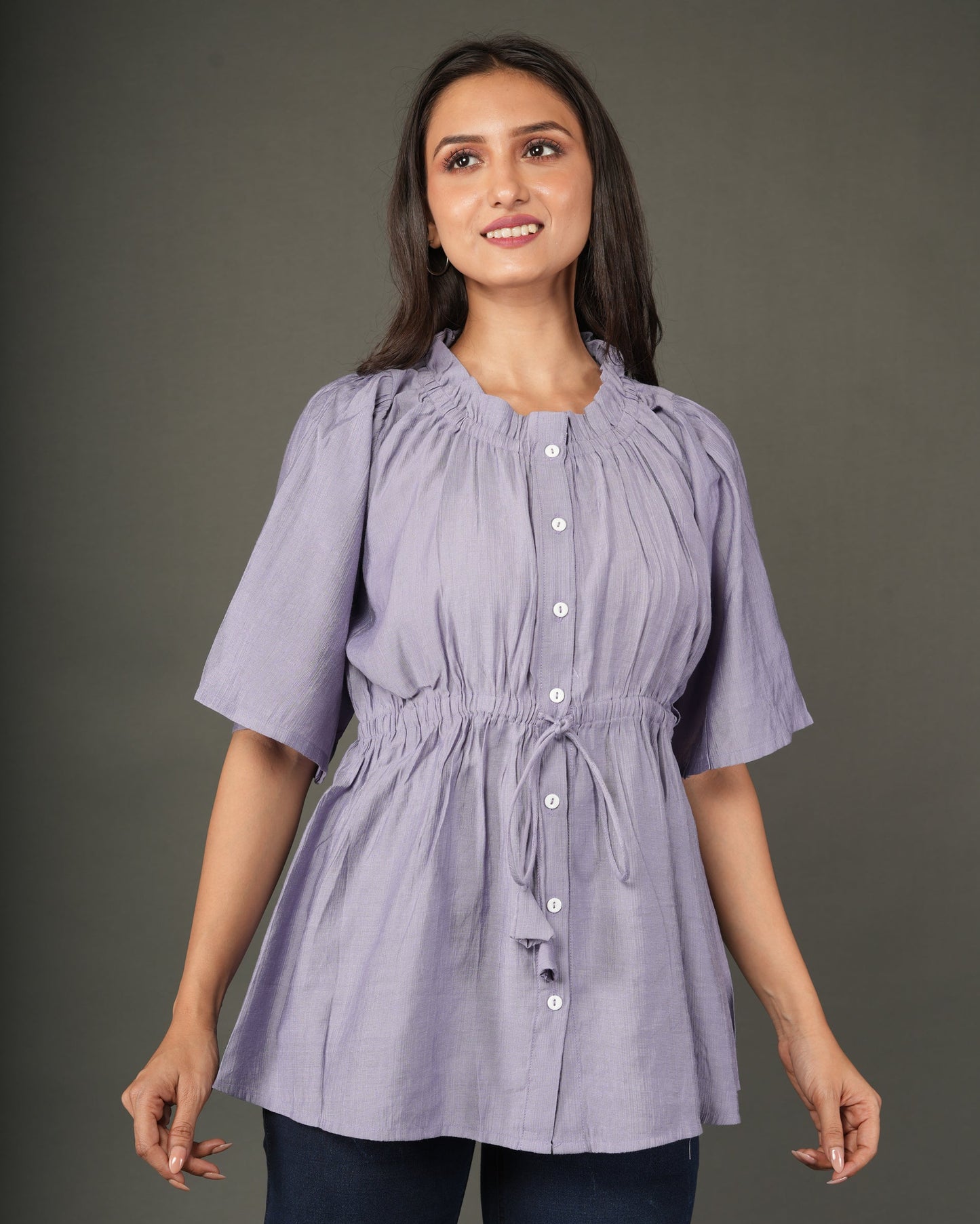 A woman modeling a lavender short-sleeve peplum top