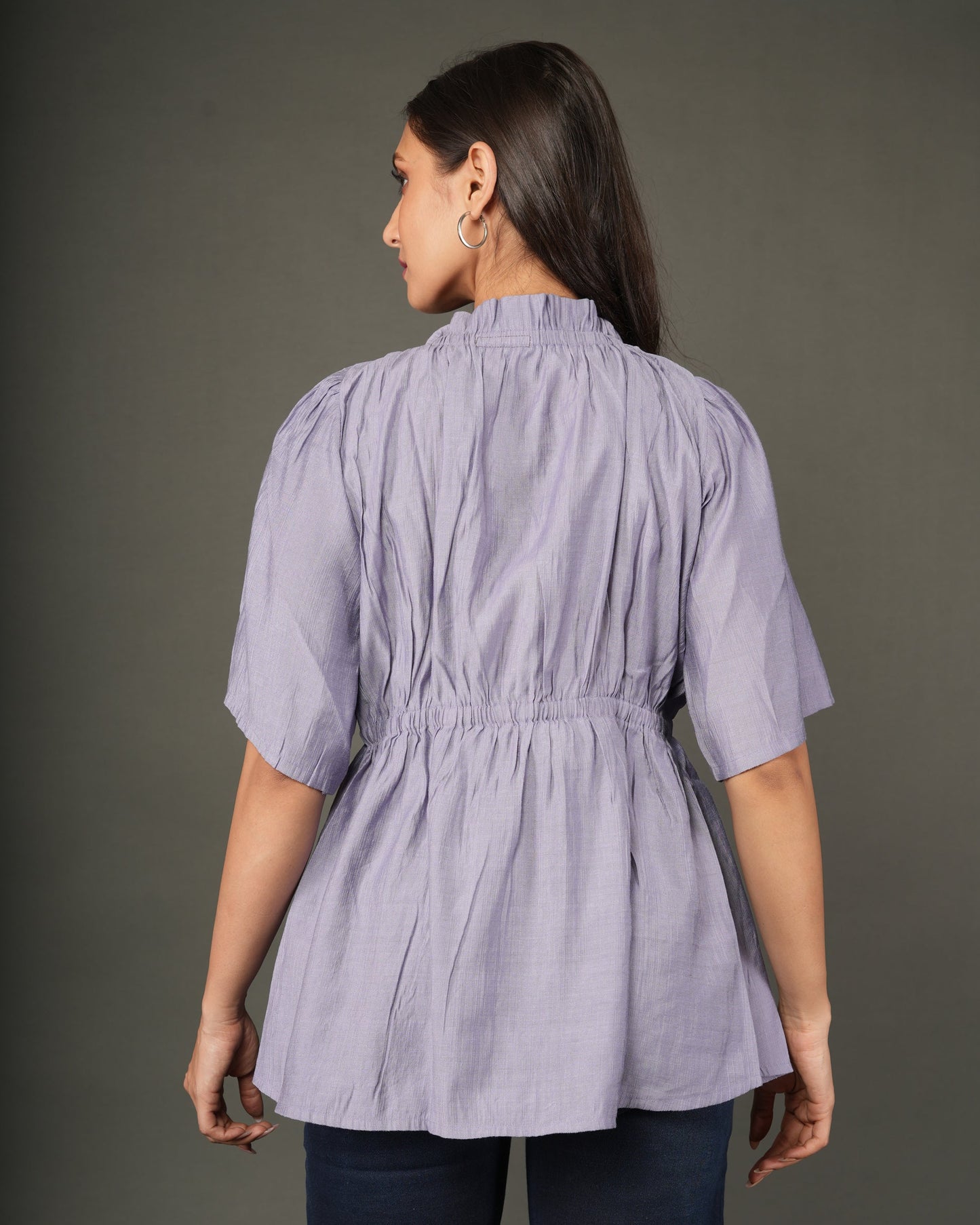A woman modeling a lavender short-sleeve peplum top