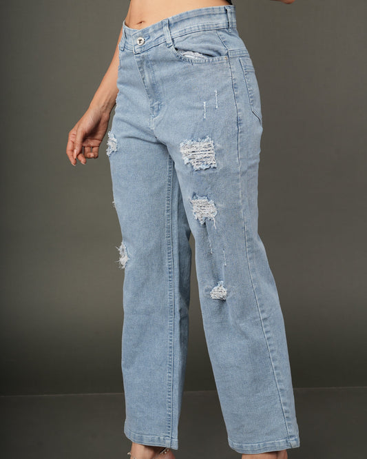 A model wearing light-wash blue distressed jeans with ripped details, paired with a dark navy satin crop top.