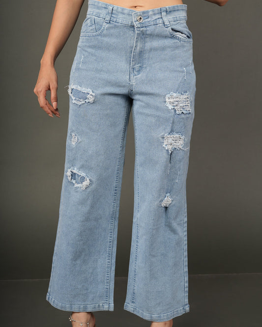 A model wearing light-wash blue distressed wide-leg jeans, paired with a dark navy satin crop top.