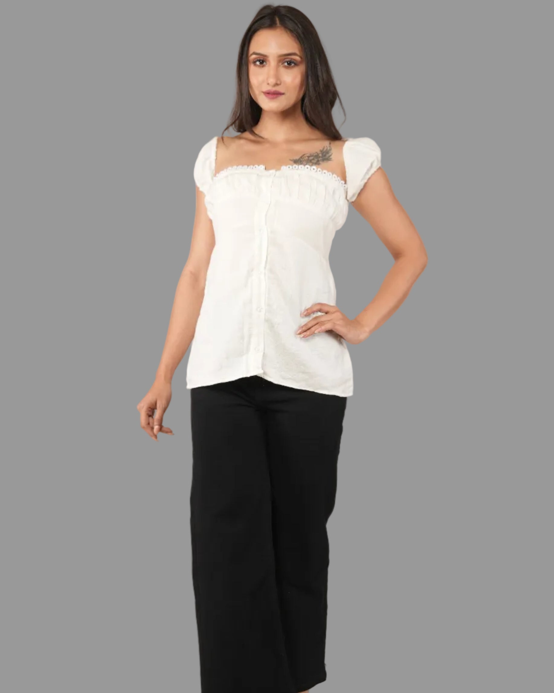 A women modelling a white short-sleeve top with a ruffled off-the-shoulder neckline with front button placket and black pants.