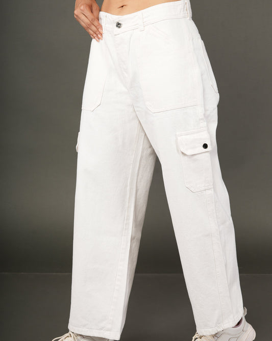 A person wearing white wide-leg cargo pants with a cropped orange top and white sneakers.