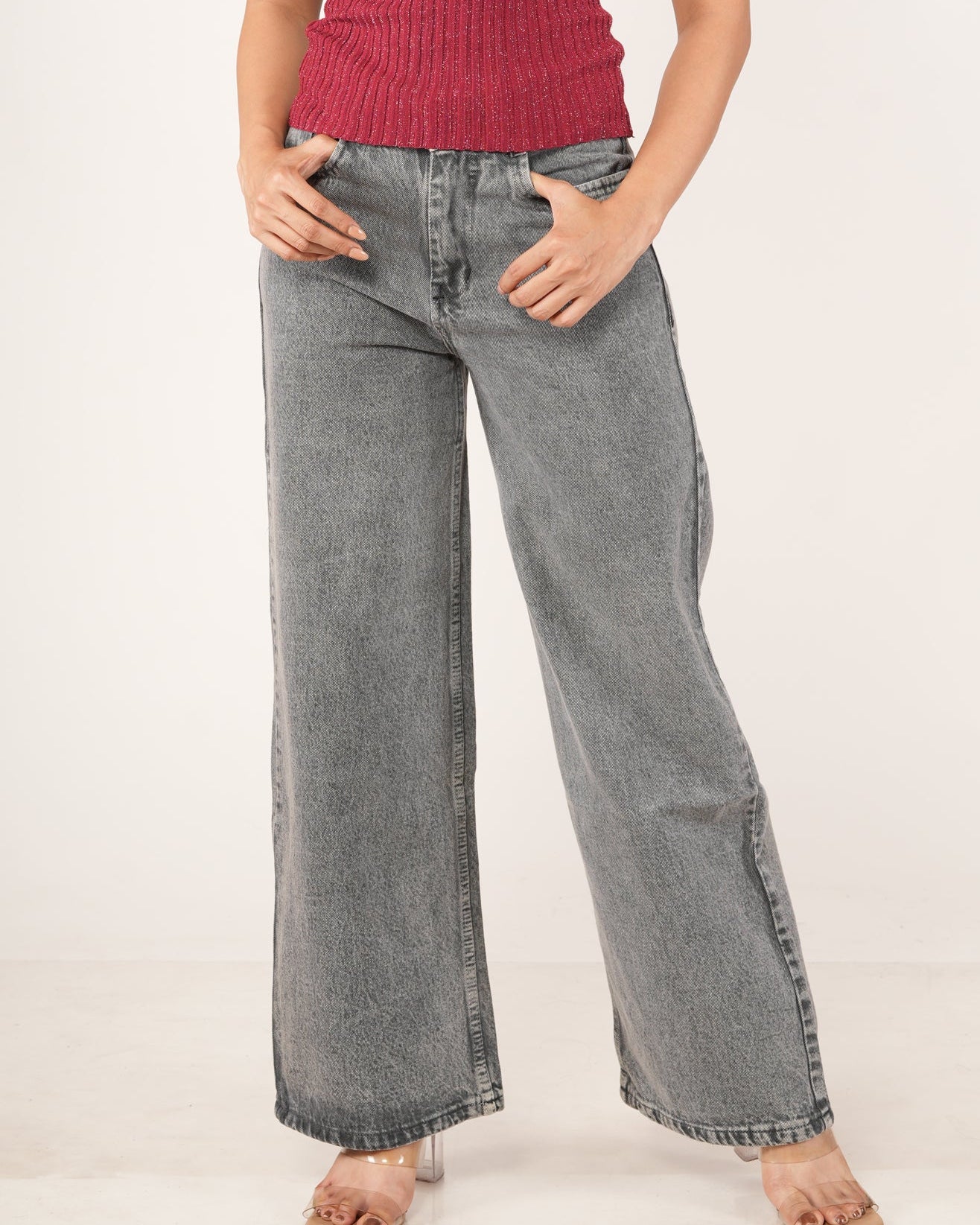 A woman modeling a  wide-leg gray jeans.
